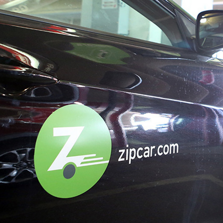 A Zipcar parked in a garage