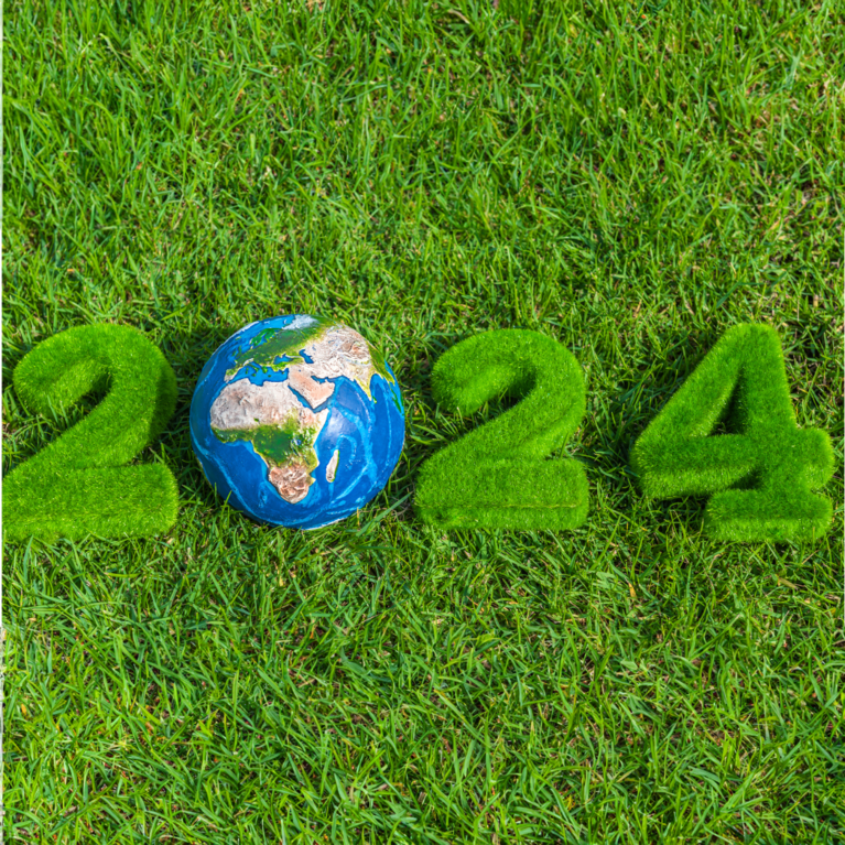 2024 written in grass with a globe as the 0